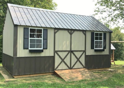 A 10x16 Metal Lofted Garden Shed with Lt. Stone walls and Burnished Slate roof, trim, and optional wainscoting. Also shown with Black optional shutters and window boxes.